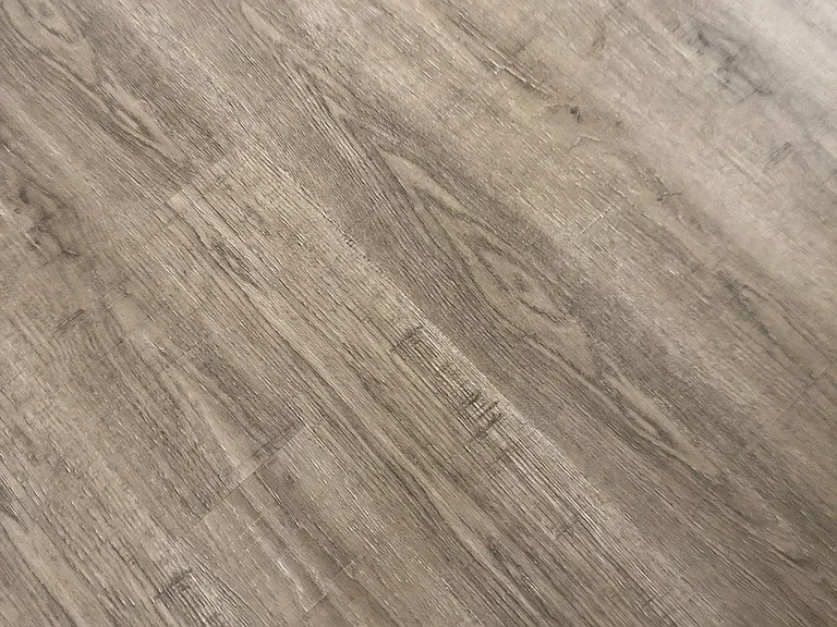 New vinyl plank flooring in gray/tan wood like pattern and colors.