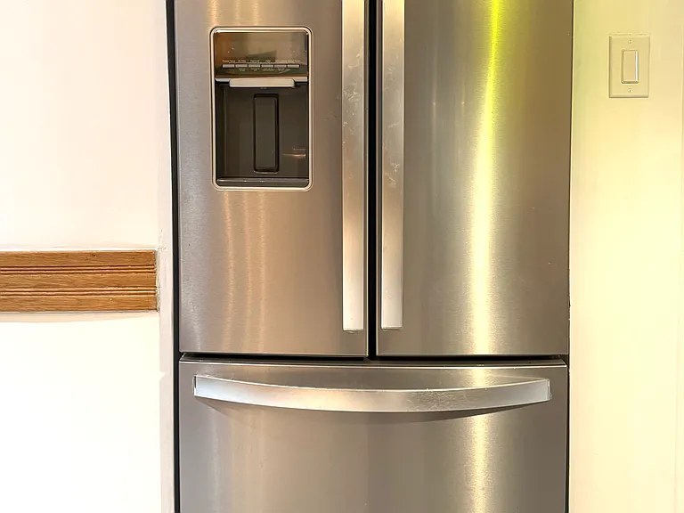 French door refrigerator with bottom freezer and water dispensor and ice maker.