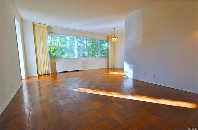 The large living room and "L" shape dining room with a bank of windows over looking tree lined Garth Road.  There is a door leading to a sunny private balcony.  The living room is 20'-0" x 12'-0" the foyer is an additional 10'-8" x 8'-2" and the dinig are