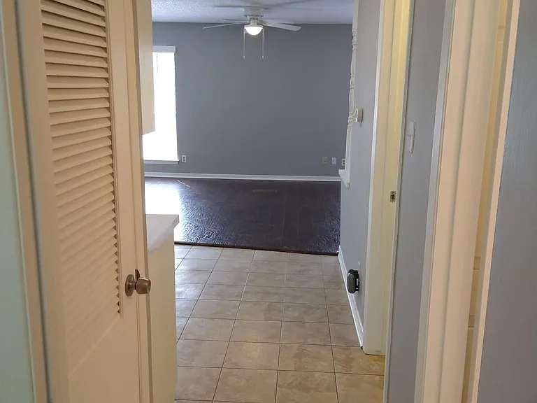 View towards kitchen and living area from bedroom door.