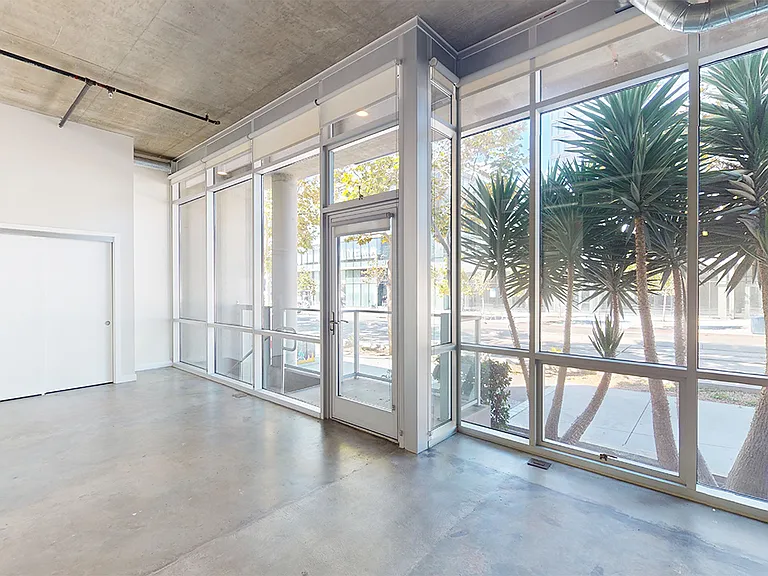 Apartment living room with concrete or wood-style flooring.