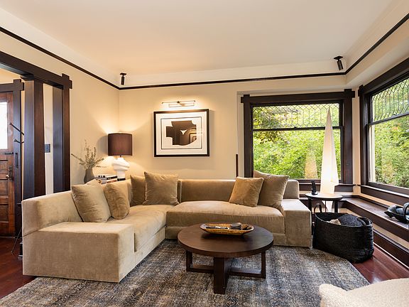 Living room with built in seating and bay windows
