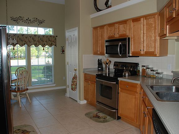 Kitchen has large windows that face the street