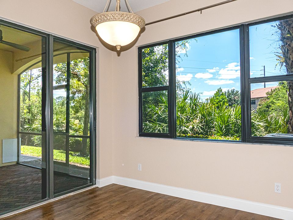 View from Dining Room to backyard (pond) and screened patio