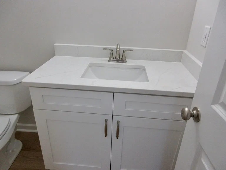 Primary bedroom quartz topped cabinet