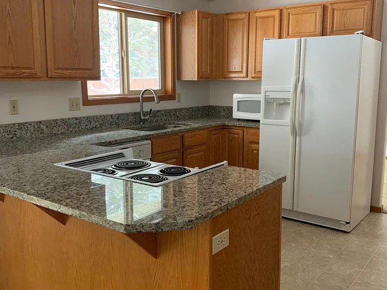 Kitchen view with new granite. Microwave included