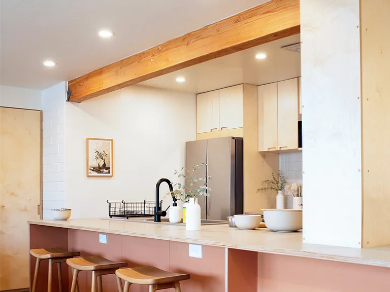Modern kitchen with breakfast bar seating and open layout.