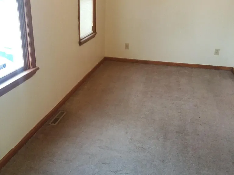 Large carpeted Master Bedroom with 2 windows, ceiling fan; looking away from closet