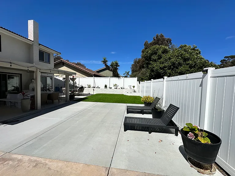 Back Patio- With new turf and recently done concrete. 
New fence