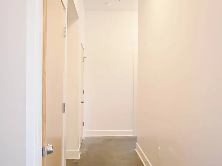 Hallway with overhead lighting in a unit at The Sawyer.