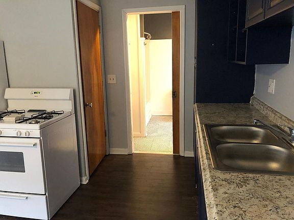 View of bathroom entrance from kitchen - entrance to basement is on the door on the left