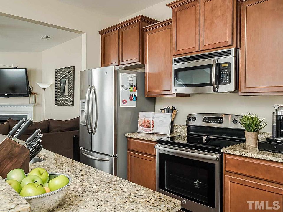 This Home will wow you!! Many Many upgraded features throughout this nearly new home! Granite breakfast bar, Steel French door refrigerator, maple cabinets! View of the granite countertops, stainless steel stove and microwave! The gas burning fireplace!