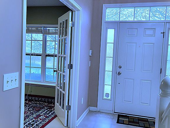 Welcome to a bright and inviting first floor featuring a spacious foyer and a stylish office with French doors _ perfect for remote work or a quiet retreat right by the front entrance.