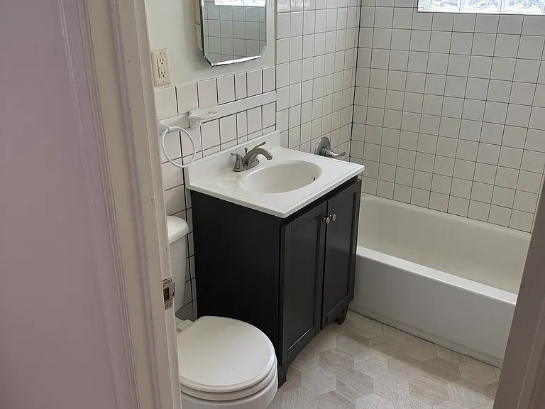 Updated main floor bath with tile shower. & walls, new vinyl floor