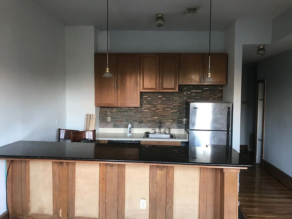 The kitchen/Living Room includes granite countertops/bar stone accent backsplash and stainless steel appliances.