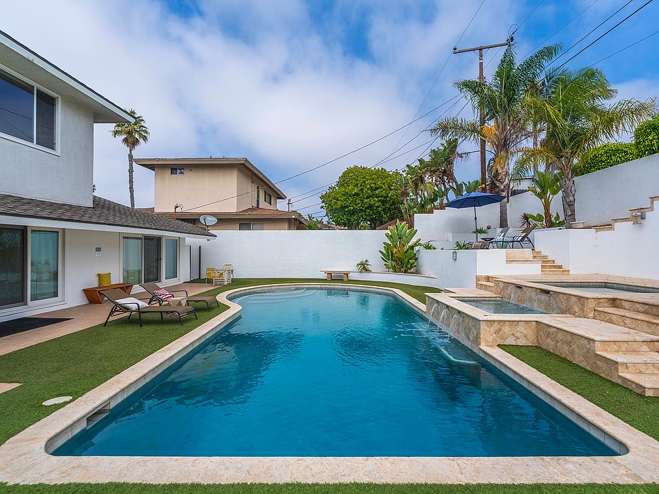 Outdoor oasis with large pool, 2 jacuzzis/spas, putting green, and low maintenance turf.