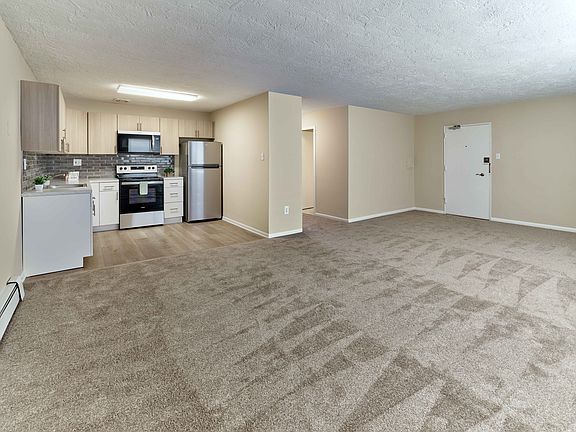 Bright and open living space with modern kitchen at Audubon Arms Apartments