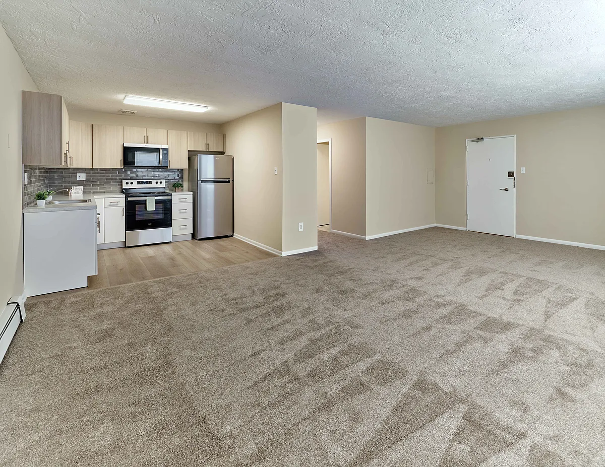 Bright and open living space with modern kitchen at Audubon Arms Apartments - Audubon Arms