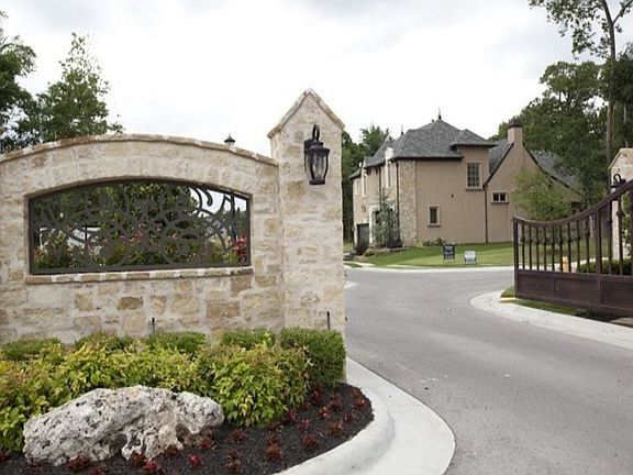 Scroll Iron Work adorns the stone wall at entrance