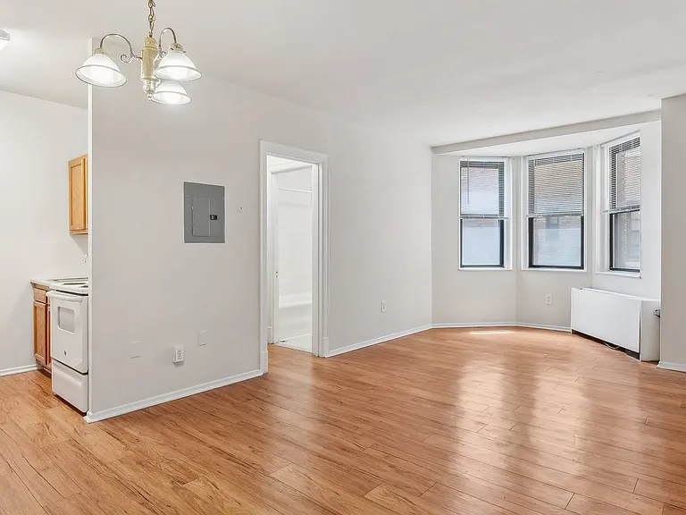 Spacious living space with natural light and wood flooring