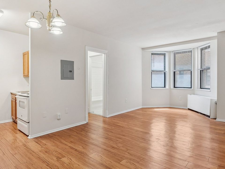 Spacious living space with natural light and wood flooring
