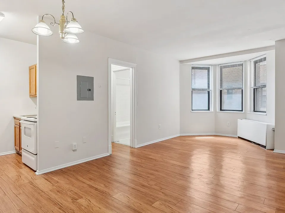 Spacious living space with natural light and wood flooring