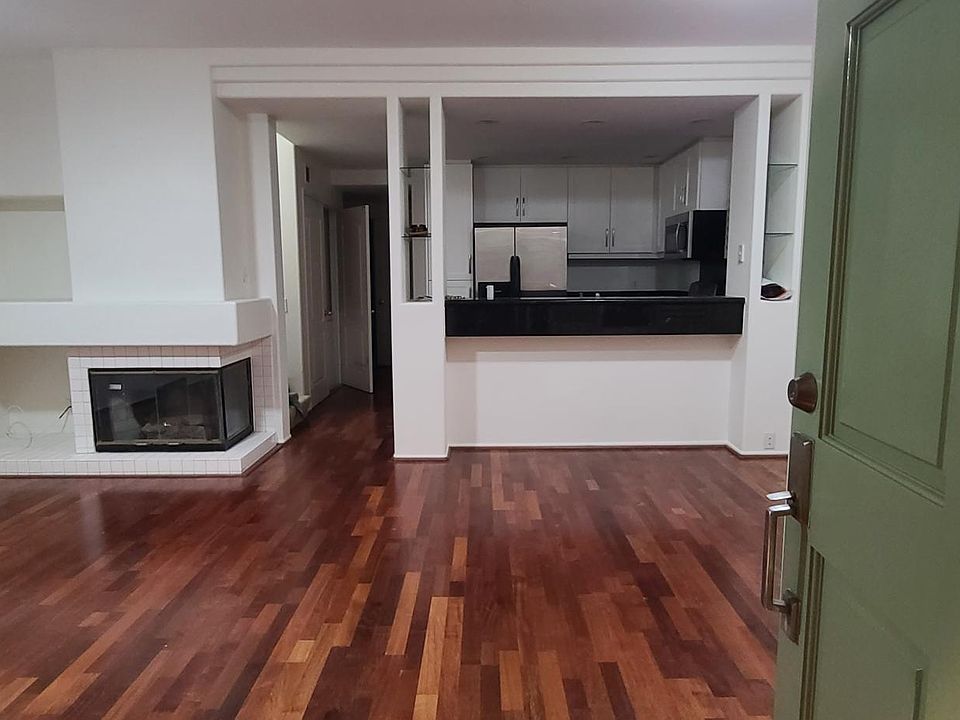 Open Living room/Dining room with wood floors and great lighting