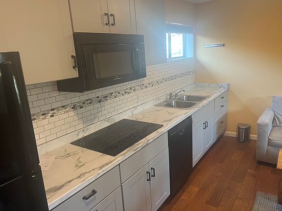 full sized kitchen with micro wave oven, stovetop, and dishwasher