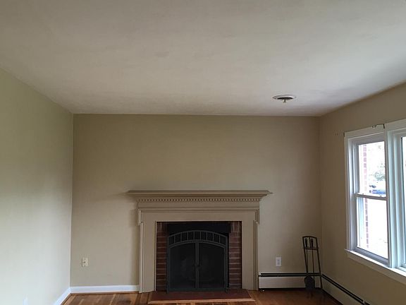 wood burning fireplace in living room