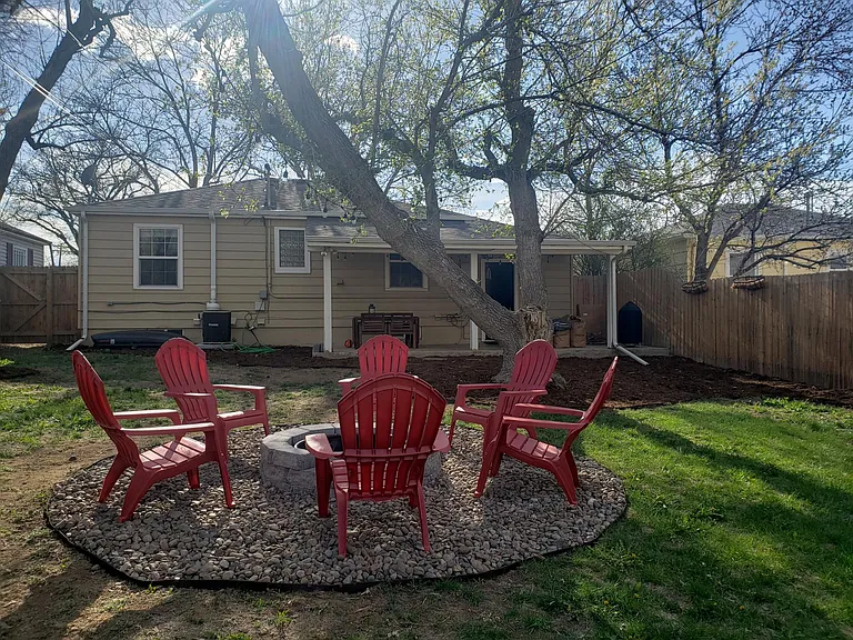 Large fenced in & gated backyard w/ covered deck and firepit area. Chairs available upon request.