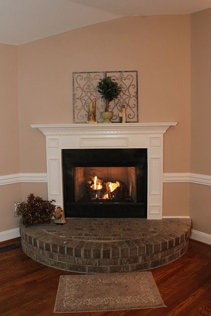 Beautiful fireplace with brick hearth and gas logs