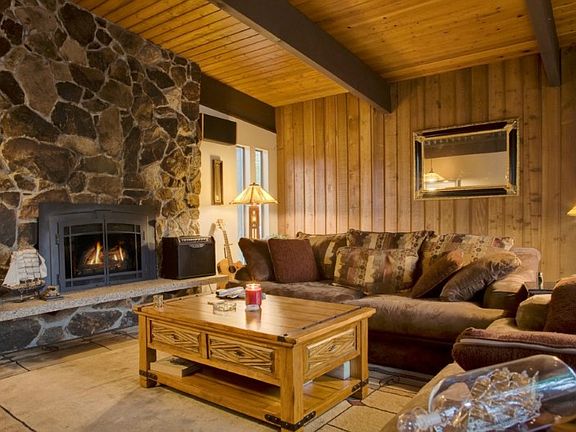 Great Room...spacious & inviting! Gas fireplace & vaulted wood ceilings with exposed beams. Wonderful place to relax!