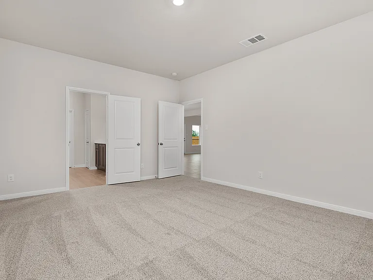 The master suite has a large bedroom, ensuite bathroom and a walk-in closet.