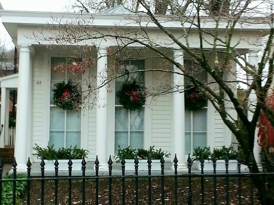 103 E. Third Street. Front porch. Cast iron gate and fence. Brick walkway leading to side entrance.