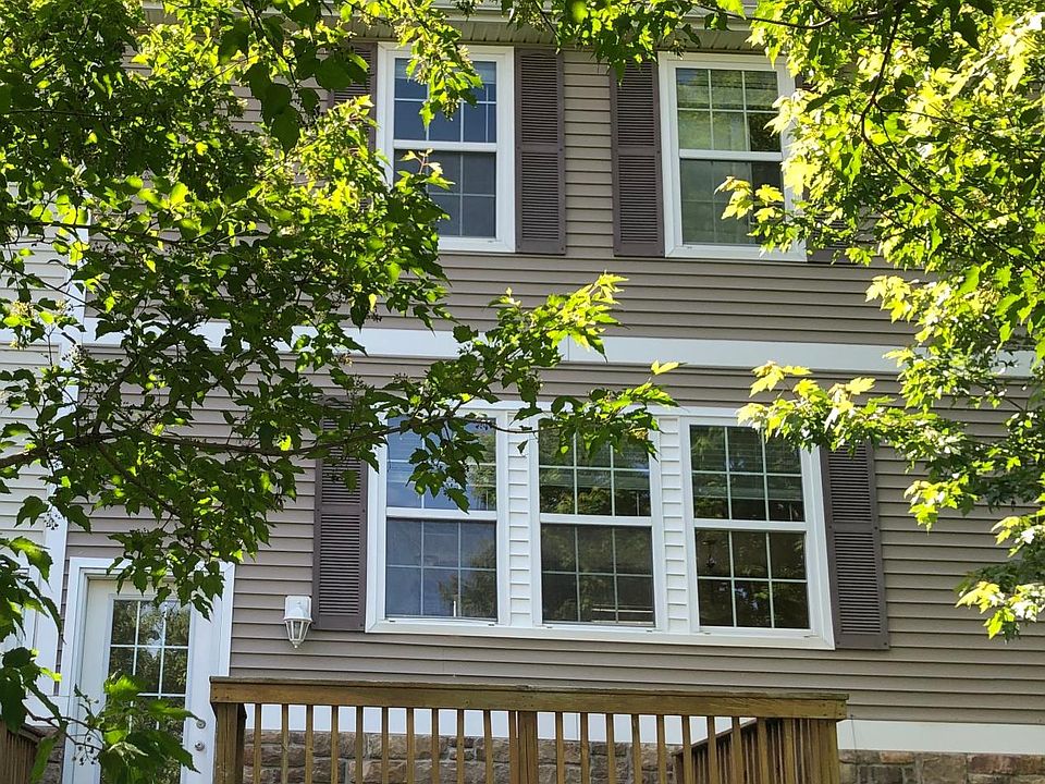 Looking from the road at the back side of the house including the deck and entryway