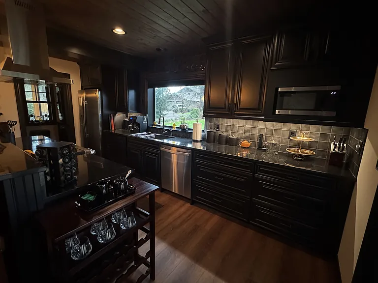 Walk-through kitchen with ample storage, flowing into the pantry and laundry area.
