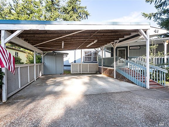 Spacious double carport and gradual stairs up to oversized front porch.