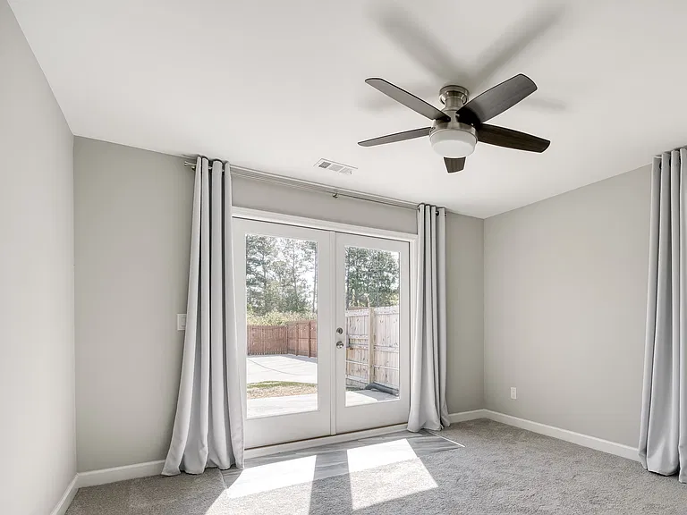 The second bedroom features French doors that open onto the patio.