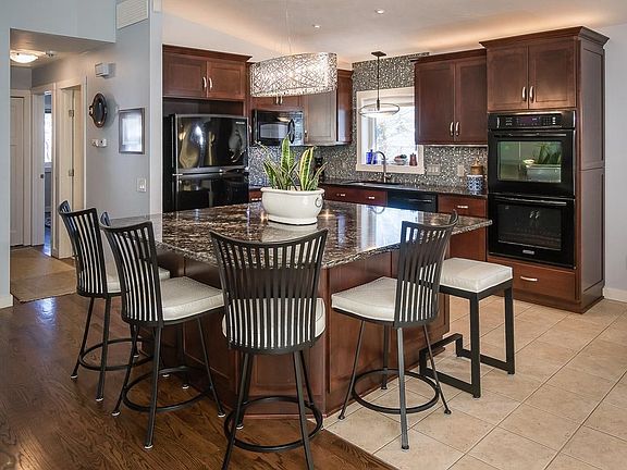 Kitchen has slow closing drawers and plenty of extra storage space under the center island. Matching black KitchenAid appliances.