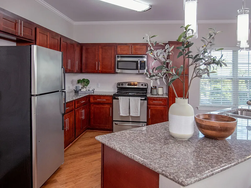 Entertain in style with our two-bedroom kitchens, boasting cherry wood cabinets and luxurious granite countertops for the perfect ambiance.