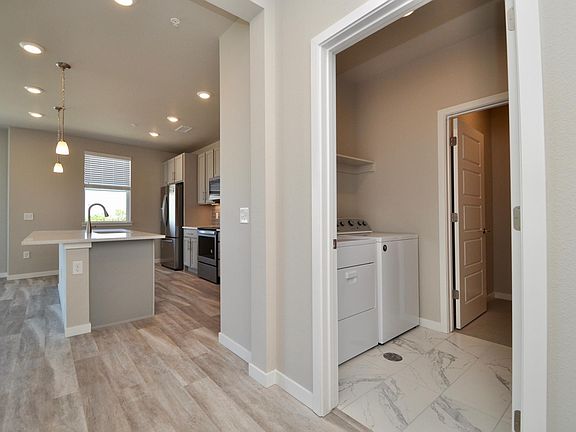 Entryway looking into kitchen and laundry room with master closet beyond
