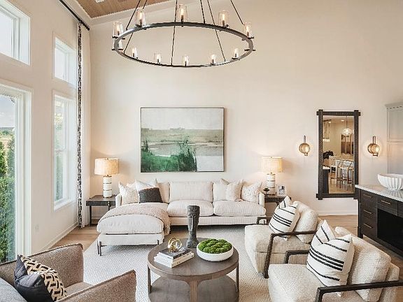 Soaring two-story great room with floor to ceiling windows and an abundance of natural light