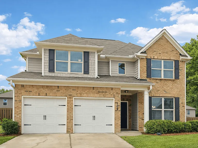 Exterior of the Martin Layout, two story home with a private driveway and attached garage.