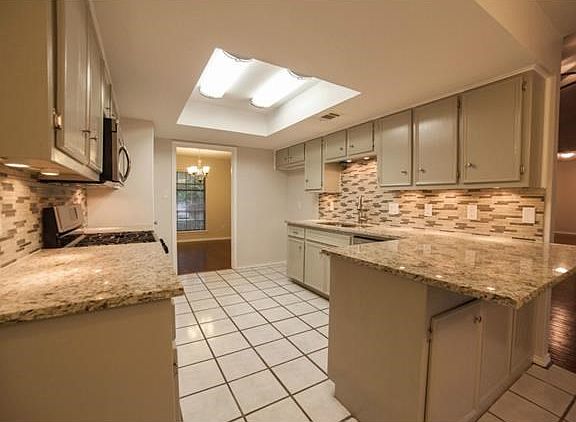 The kitchen has been updated with granite counters, designer back splash, stainless microwave, stainless stove, and dishwasher.  This is a dream kitchen!