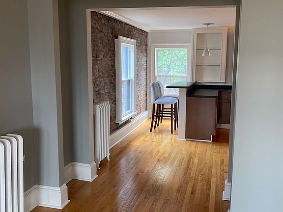 Sunlit living room looking into kitchen