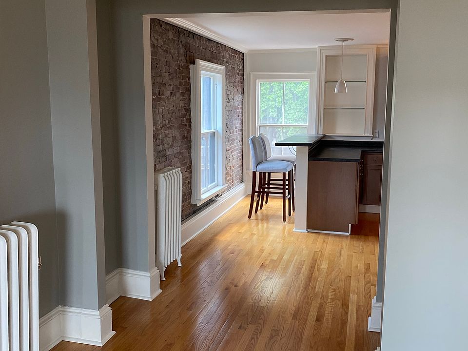 Sunlit living room looking into kitchen
