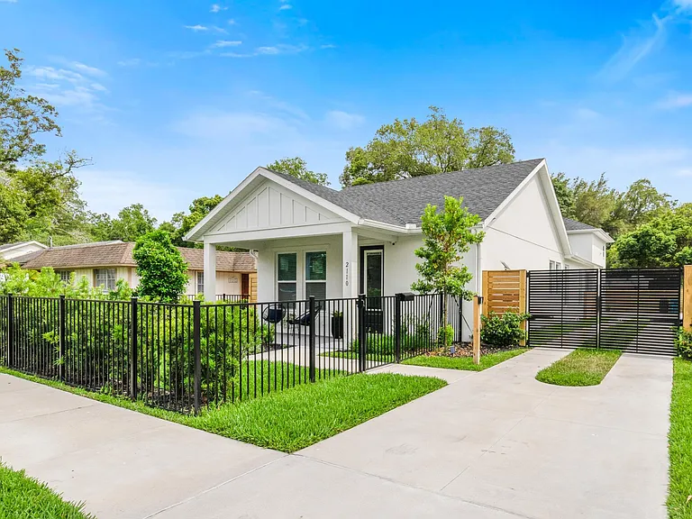 The guest house sits behind the gates and over the 2-car detached garage. Parking space for the unit is located behind the gates as well on a parking pad just off of the guest house.
