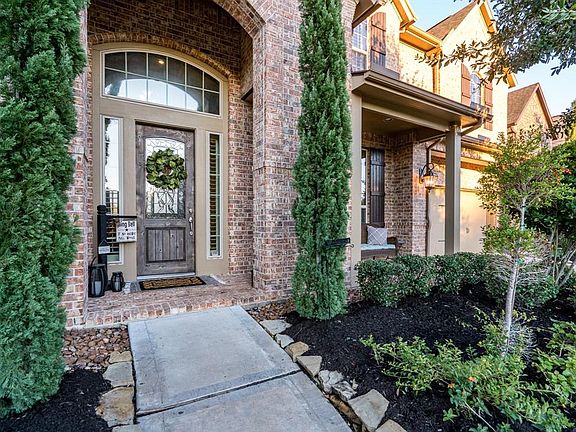 This home offers great curb appeal with a covered front porch that overlooks well maintained stacked stone flowerbeds with pretty foliage and mature trees!