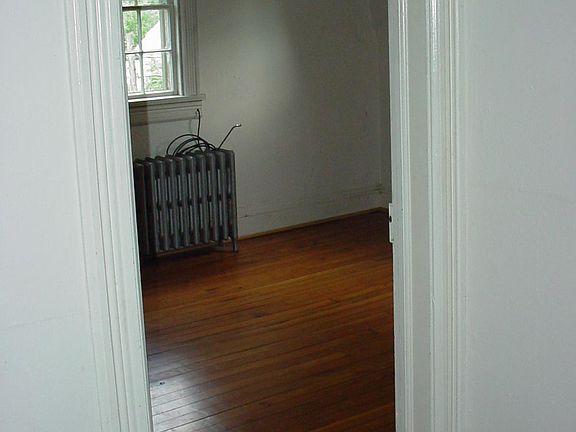 A peek at the Master Bedroom and top of old banister on a storage or work cubby.