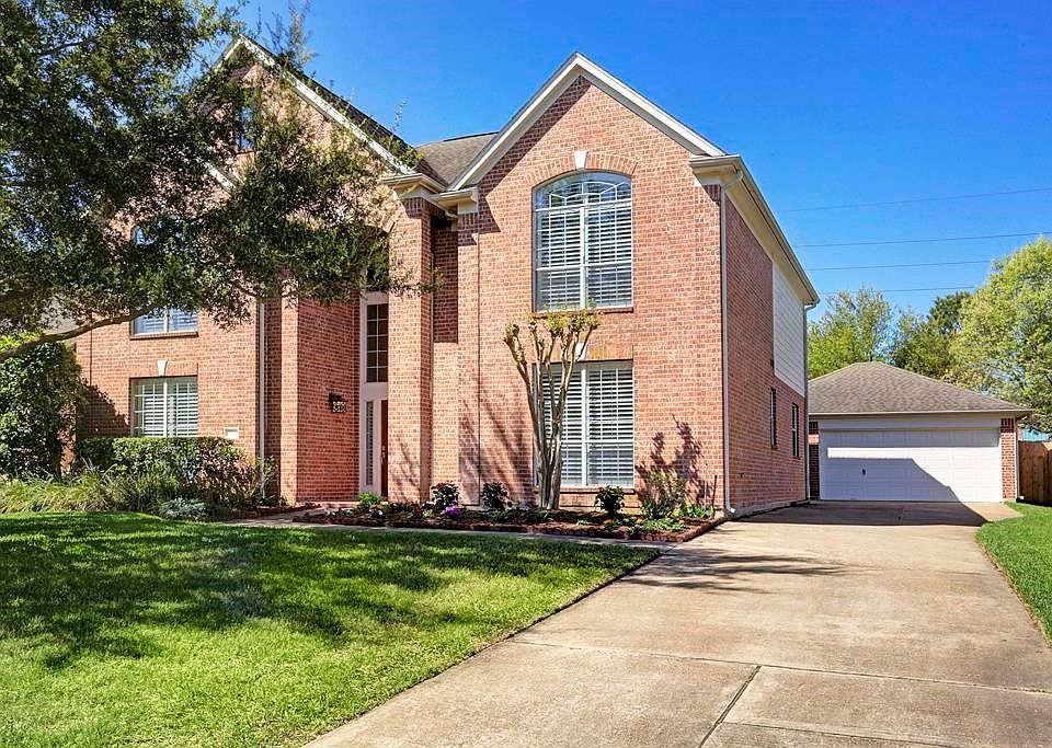 Stately 2-story brick house on large lot with mature trees